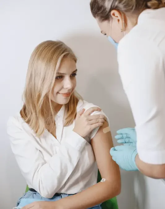 Healthcare professional administering a vaccine at an immunisations clinic in Canberra, helping a child, adult, or traveller stay protected with recommended vaccinations in a modern medical clinic.